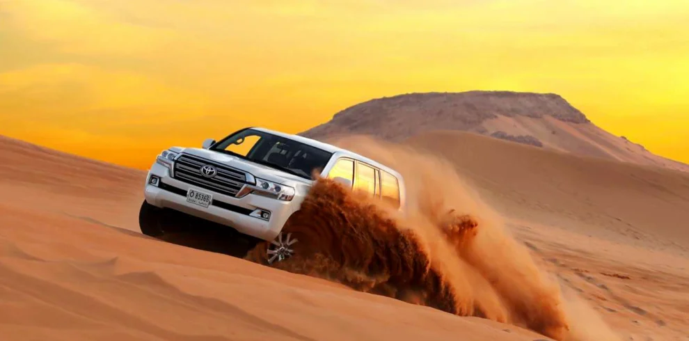 Desert Safari in Dubai – An Unforgettable Arabian Adventure | WPJ Travel | WPJ Travel 6 4x4 vehicle dune bashing during Dubai desert safari at sunset
