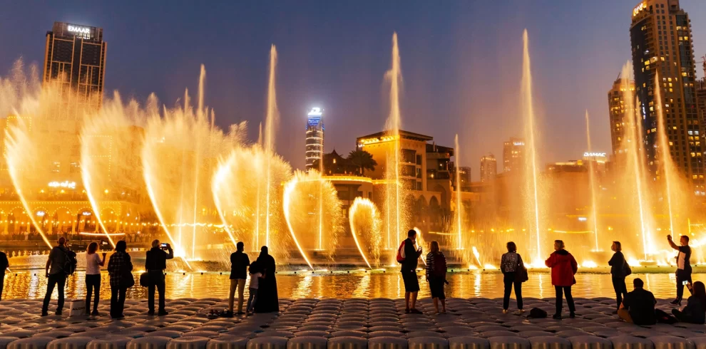 Dubai Fountain Show & Lake Ride Tickets | Abra Boat Ride at Burj Khalifa | WPJ Travel | WPJ Travel 5 Tourists enjoying the Dubai Fountain Show and Lake Ride with Burj Khalifa illuminated in the background.