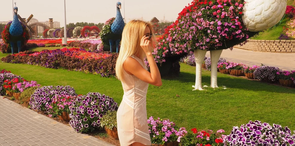 Dubai Miracle Garden Tickets | World’s Largest Flower Park | WPJ Travel | WPJ Travel 8 Visitors walking through colorful floral archways at Dubai Miracle Garden.