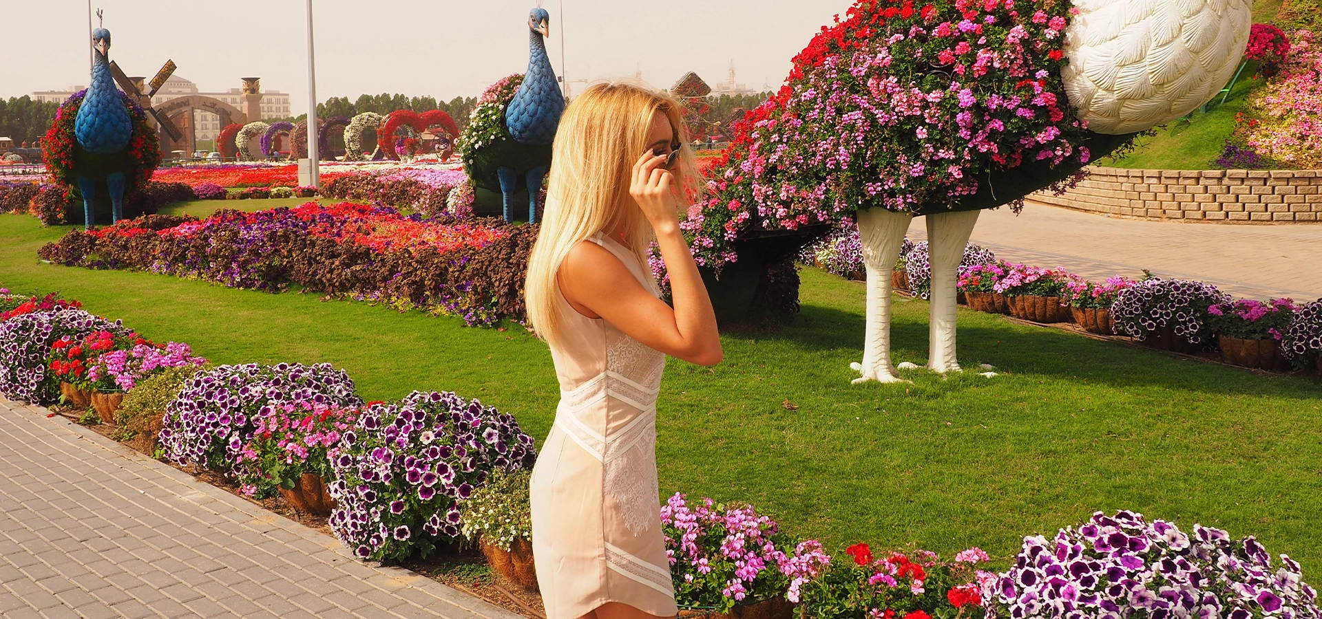 Visitors walking through colorful floral archways at Dubai Miracle Garden.