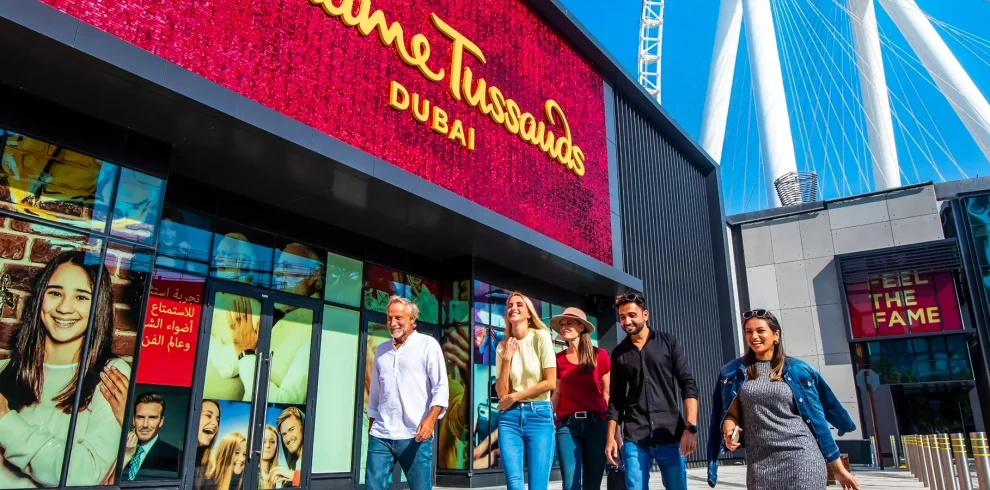 Visitors posing with wax figures of celebrities at Madame Tussauds Dubai on Bluewaters Island