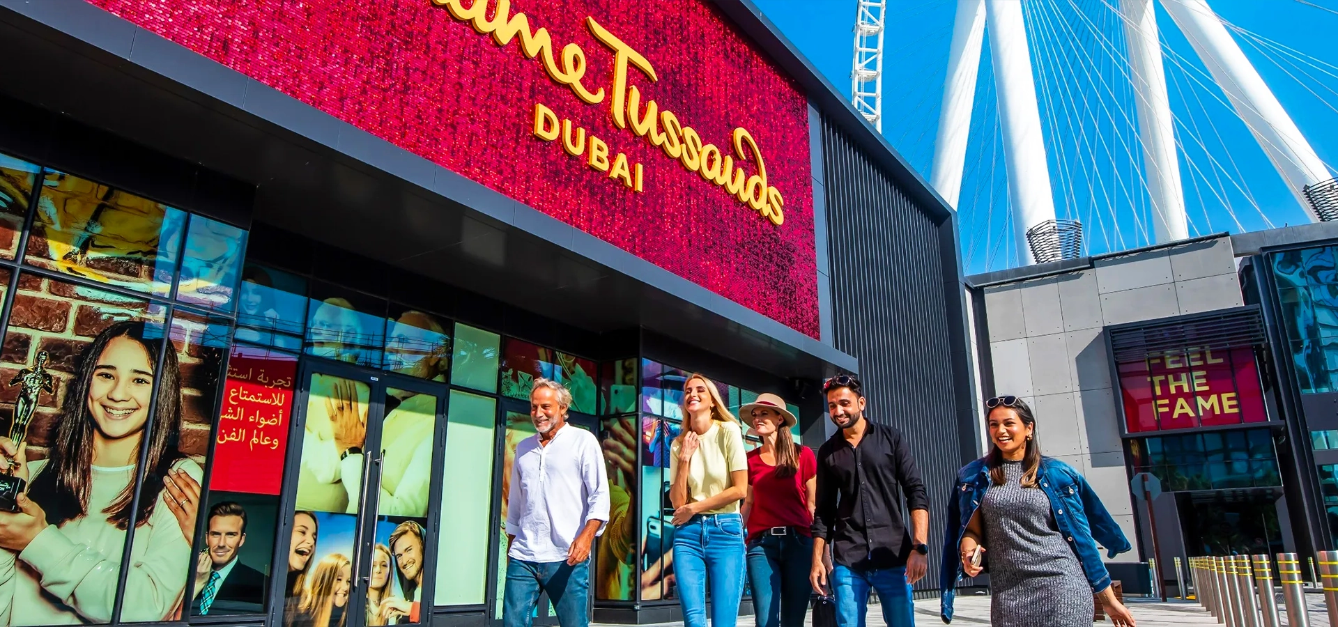 Visitors posing with wax figures of celebrities at Madame Tussauds Dubai on Bluewaters Island