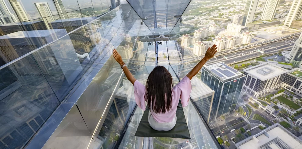 Sky Views Dubai Tickets | Glass Slide & Observatory Experience | WPJ Travel | WPJ Travel 10 Tourists enjoying the glass slide and observation deck at Sky Views Dubai with a panoramic view of Burj Khalifa