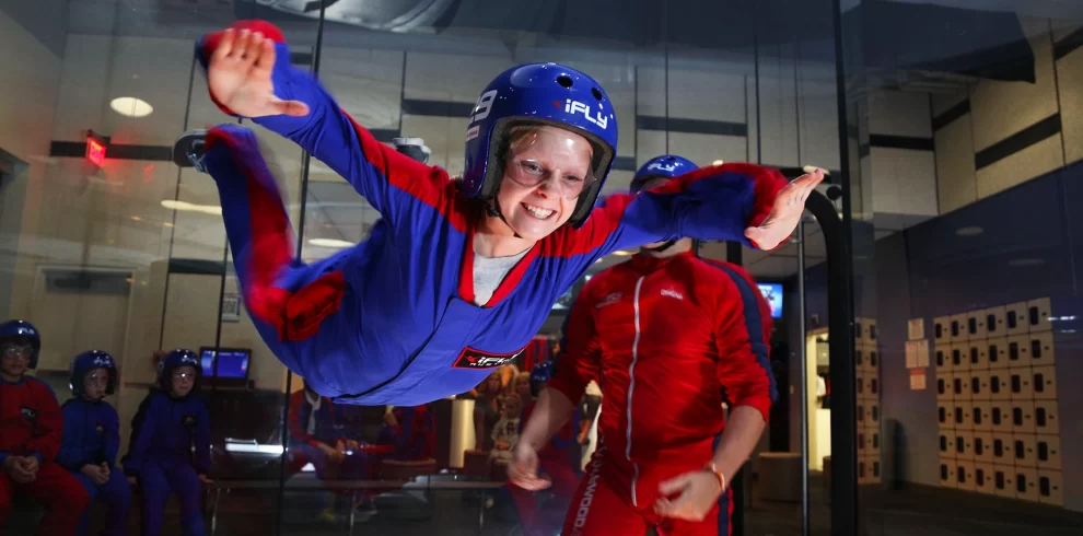 iFly Dubai | Indoor Skydiving Experience Tickets | WPJ Travel | WPJ Travel 3 Guest floating mid air inside iFly Dubai’s indoor skydiving wind tunnel.