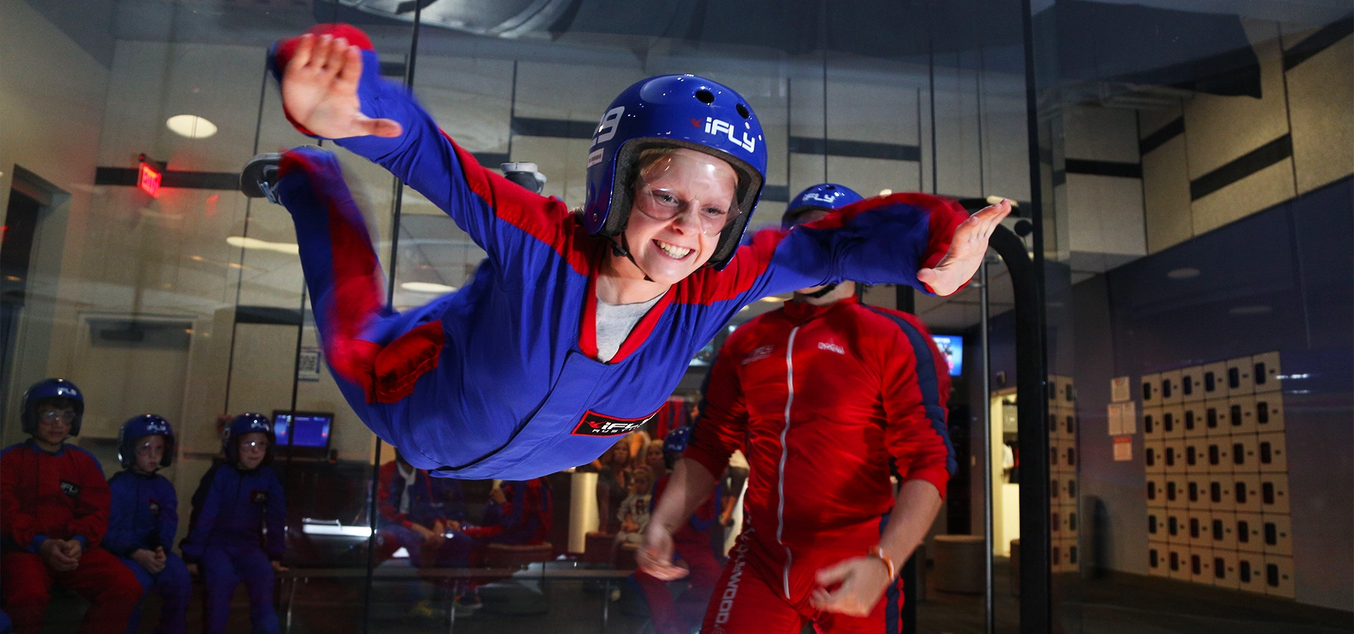 Guest floating mid air inside iFly Dubai’s indoor skydiving wind tunnel.