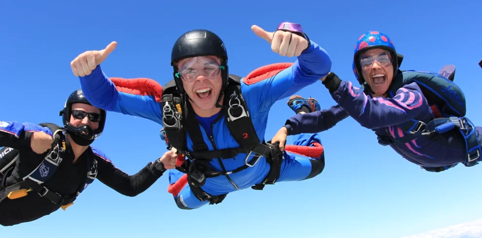 Skydive Dubai Tickets | Tandem Skydiving Over Palm Jumeirah & Desert Dropzone | WPJ Travel | WPJ Travel 6 Tandem skydiver freefalling over Palm Jumeirah with stunning aerial Dubai skyline view.